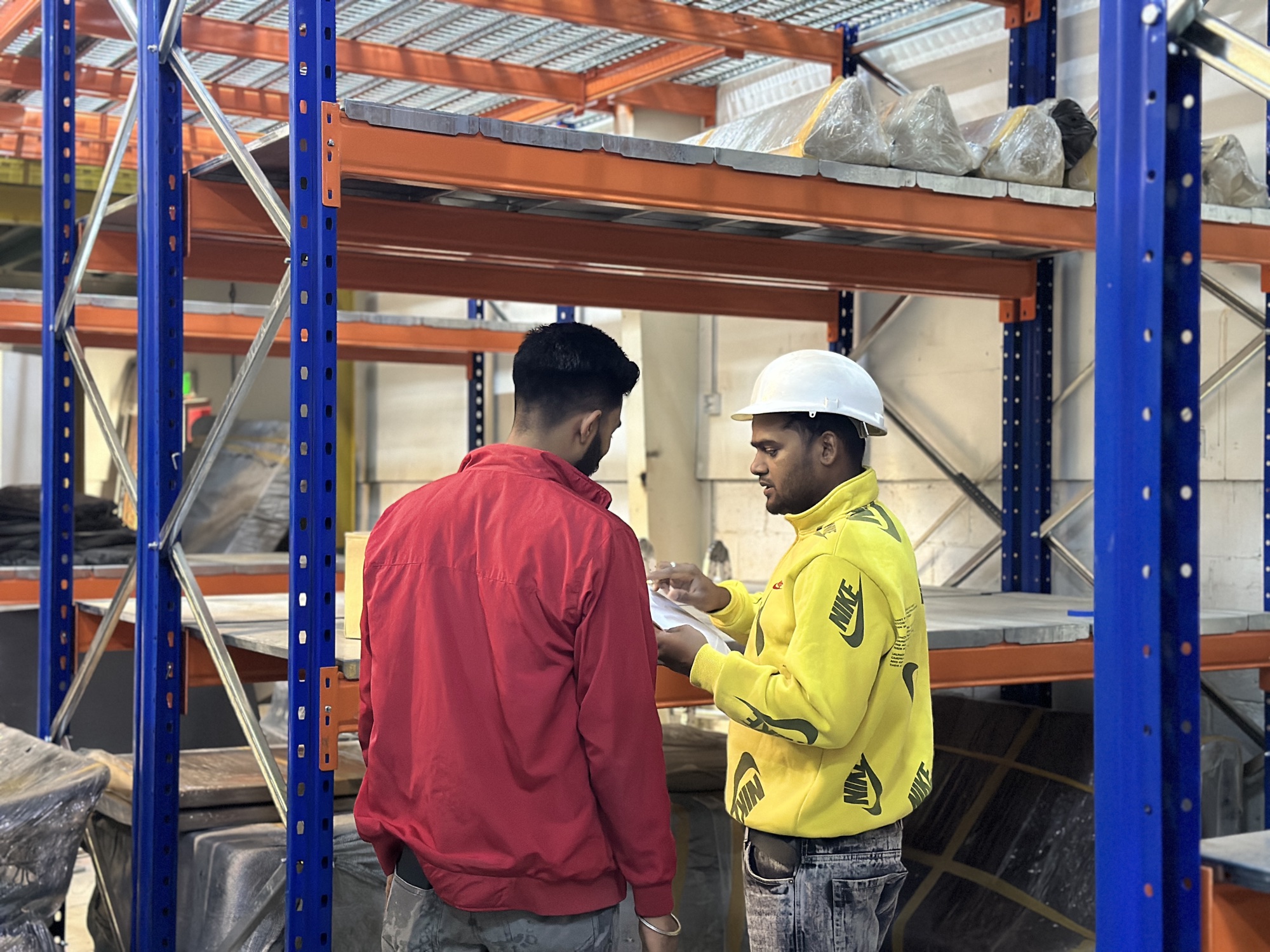 Two of the team going through a job on the workshop floor